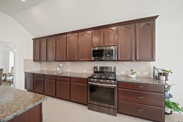 20719 Kerby Pl, Cypress, TX 77433 - kitchen with stainless steel appliances, vaulted ceiling, decorative backsplash, light stone countertops, and dark brown cabinetry