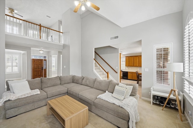 13819 Marbledale Ct, Houston, TX 77059 - living room with a ceiling fan, high vaulted ceiling, stairway, light colored carpet, and baseboards