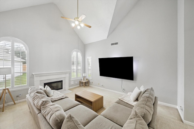 13819 Marbledale Ct, Houston, TX 77059 - living room featuring high vaulted ceiling, a ceiling fan, baseboards, light colored carpet, and a high end fireplace