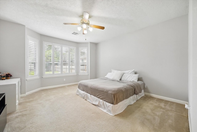 13819 Marbledale Ct, Houston, TX 77059 - bedroom with light colored carpet, a textured ceiling, baseboards, and ceiling fan