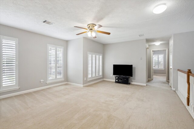 13819 Marbledale Ct, Houston, TX 77059 - unfurnished living room with a ceiling fan, light carpet, baseboards, and a textured ceiling