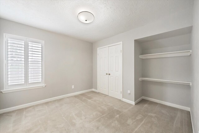 13819 Marbledale Ct, Houston, TX 77059 - unfurnished bedroom with a closet, carpet floors, baseboards, and a textured ceiling