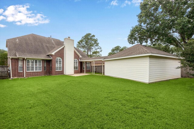 13819 Marbledale Ct, Houston, TX 77059 - back of property featuring a chimney, a patio area, brick siding, and roof with shingles