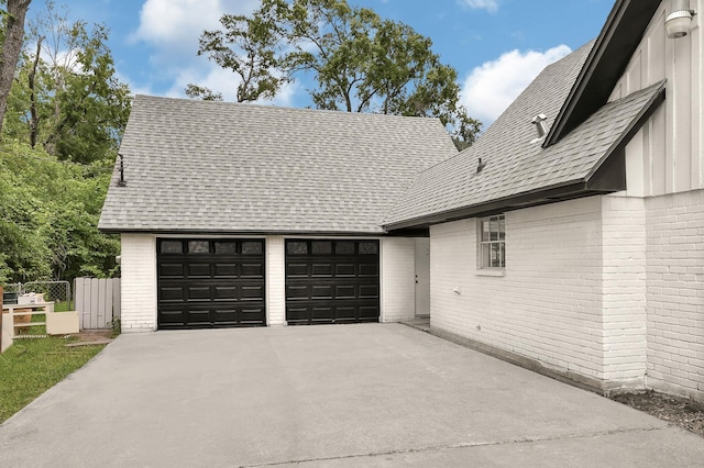 124 Rolling Wood Dr, Baytown, TX 77520 - view of front of home featuring brick siding, driveway, board and batten siding, an attached garage, and a shingled roof