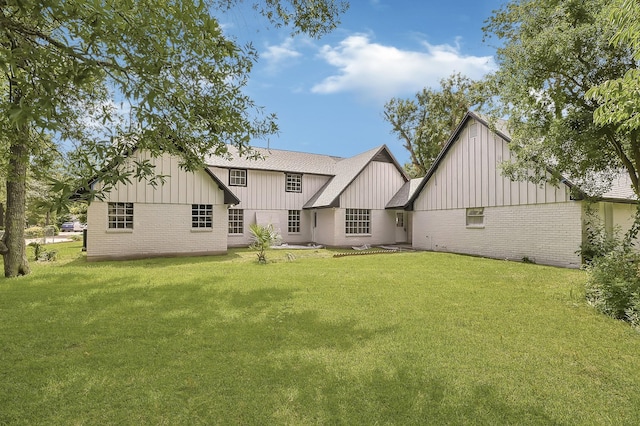 124 Rolling Wood Dr, Baytown, TX 77520 - back of house featuring board and batten siding, brick siding, a lawn, and roof with shingles