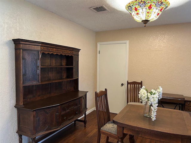 13802 Waterville Way, Houston, TX 77015 - dining room with a textured wall, dark wood-style flooring, a textured ceiling, and baseboards