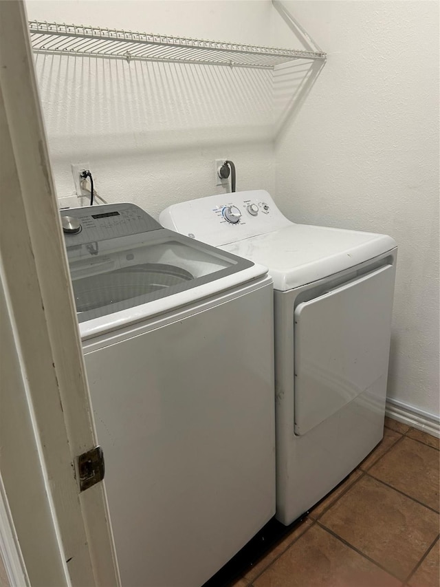13802 Waterville Way, Houston, TX 77015 - washroom featuring washing machine and clothes dryer, tile patterned floors, and baseboards