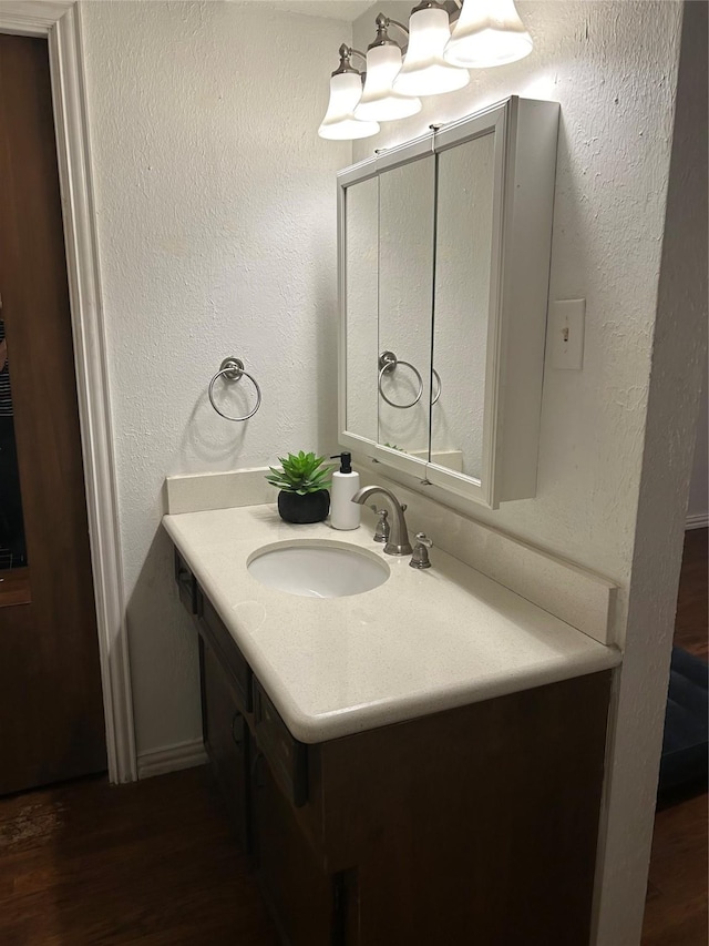 13802 Waterville Way, Houston, TX 77015 - bathroom featuring vanity, wood finished floors, and a chandelier