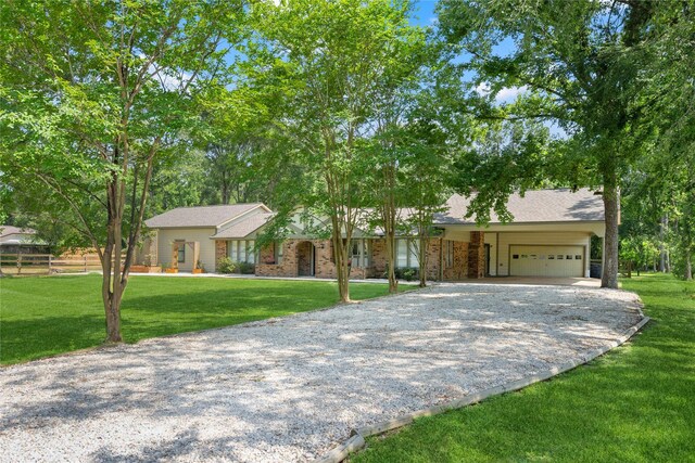 16014 Holly St, Porter, TX 77365 - view of front of home featuring gravel driveway, an attached garage, and a front yard