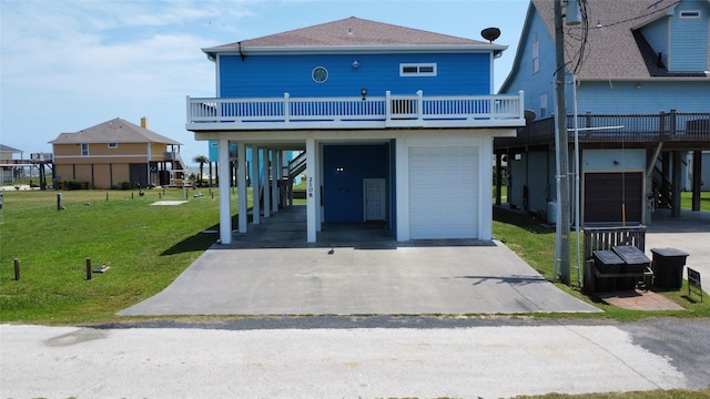 2108 Mills, Crystal Beach, TX 77650 - back of house featuring a carport, a yard, an attached garage, roof with shingles, and driveway