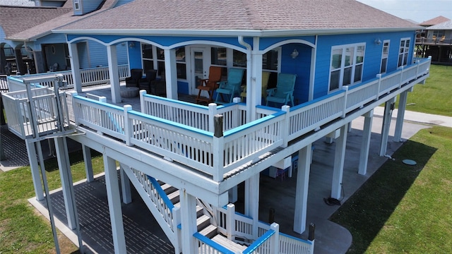 2108 Mills, Crystal Beach, TX 77650 - rear view of house featuring roof with shingles, a deck, and a yard