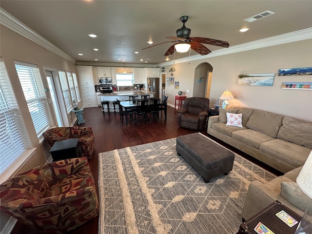 2108 Mills, Crystal Beach, TX 77650 - living room featuring arched walkways, dark wood-style flooring, ceiling fan, ornamental molding, and recessed lighting