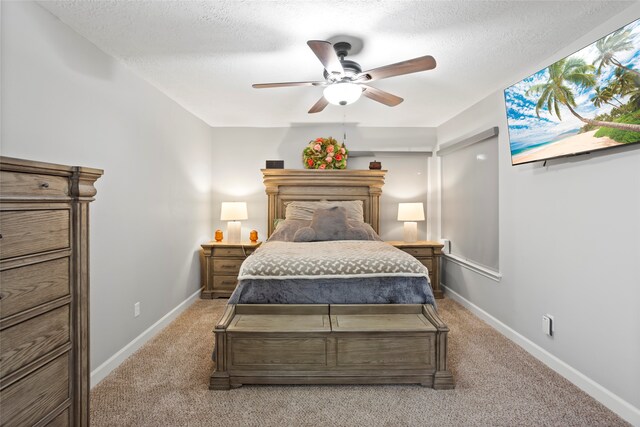 654 W Country Grove Cir, Pearland, TX 77584 - bedroom with light carpet, a textured ceiling, ceiling fan, and baseboards