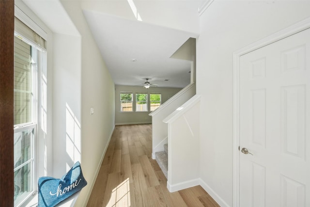 10 Fairlee Ct, The Woodlands, TX 77354 - corridor featuring light wood-type flooring, baseboards, and stairway