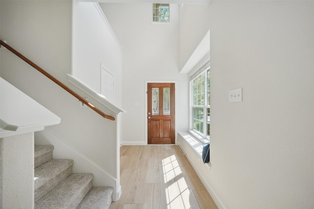 10 Fairlee Ct, The Woodlands, TX 77354 - foyer with stairway, light wood-type flooring, baseboards, and a high ceiling