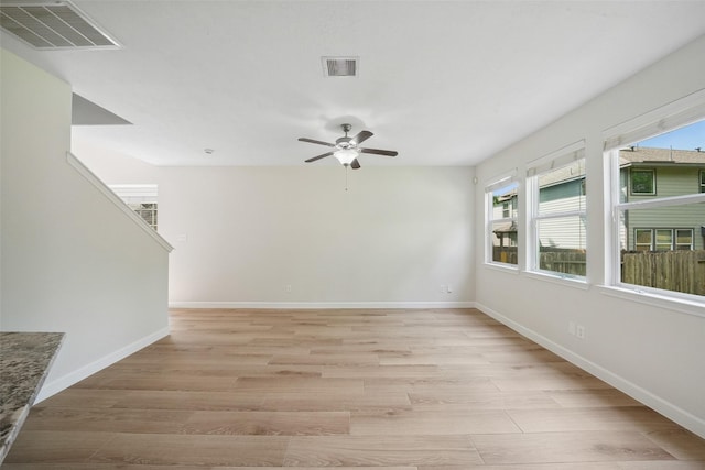 10 Fairlee Ct, The Woodlands, TX 77354 - unfurnished room with healthy amount of natural light, a ceiling fan, light wood finished floors, and baseboards