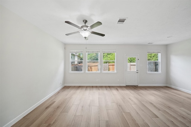 10 Fairlee Ct, The Woodlands, TX 77354 - unfurnished living room with light wood-type flooring, a ceiling fan, and baseboards