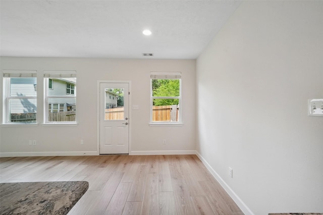 10 Fairlee Ct, The Woodlands, TX 77354 - foyer entrance with light wood-style floors and baseboards