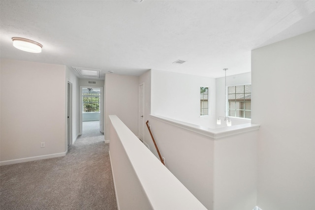 10 Fairlee Ct, The Woodlands, TX 77354 - hallway featuring an upstairs landing, light carpet, baseboards, and attic access