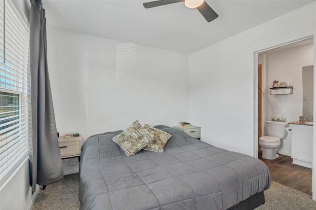 11947 Midas Ln, Willis, TX 77378 - bedroom featuring wood finished floors, connected bathroom, and ceiling fan