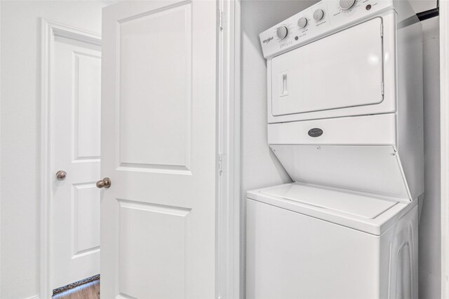 11947 Midas Ln, Willis, TX 77378 - washroom featuring estacked washer and dryer and light wood finished floors