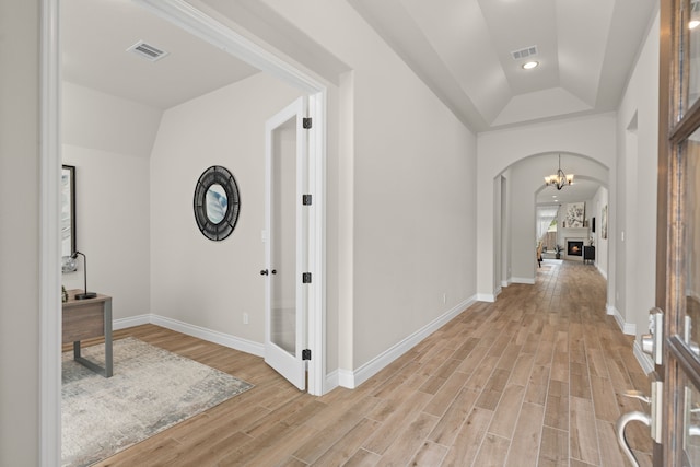 2915 Finch Ct, Katy, TX 77493 - corridor featuring light wood-style floors, arched walkways, lofted ceiling, baseboards, and recessed lighting