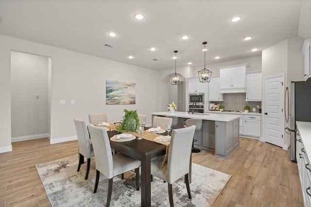 2915 Finch Ct, Katy, TX 77493 - dining space featuring recessed lighting, light wood-type flooring, baseboards, and a chandelier