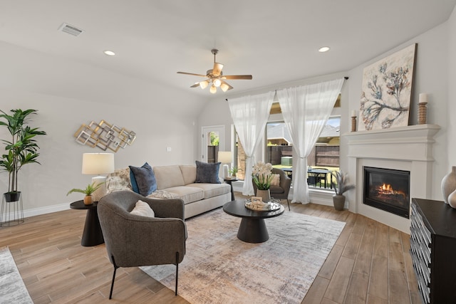 2915 Finch Ct, Katy, TX 77493 - living room with a glass covered fireplace, light wood-type flooring, ceiling fan, baseboards, and recessed lighting