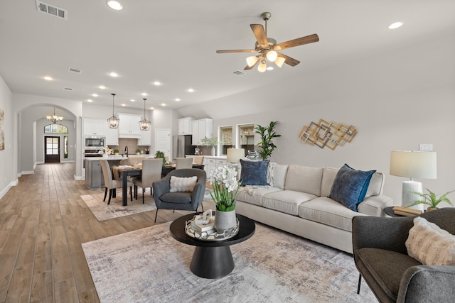 2915 Finch Ct, Katy, TX 77493 - living room featuring arched walkways, light wood-style floors, ceiling fan, recessed lighting, and baseboards