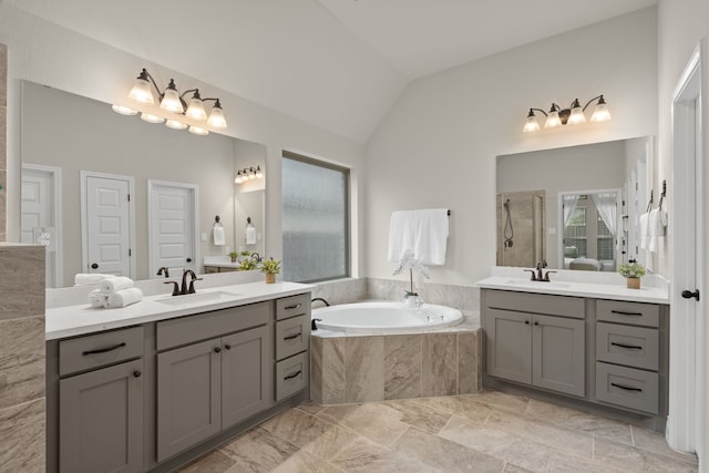 2915 Finch Ct, Katy, TX 77493 - full bathroom featuring vaulted ceiling, two vanities, a bath, and a walk in shower