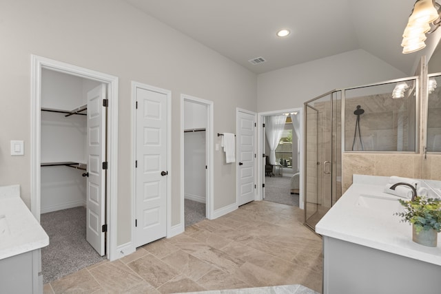 2915 Finch Ct, Katy, TX 77493 - full bathroom featuring vanity, a walk in closet, a stall shower, vaulted ceiling, and recessed lighting