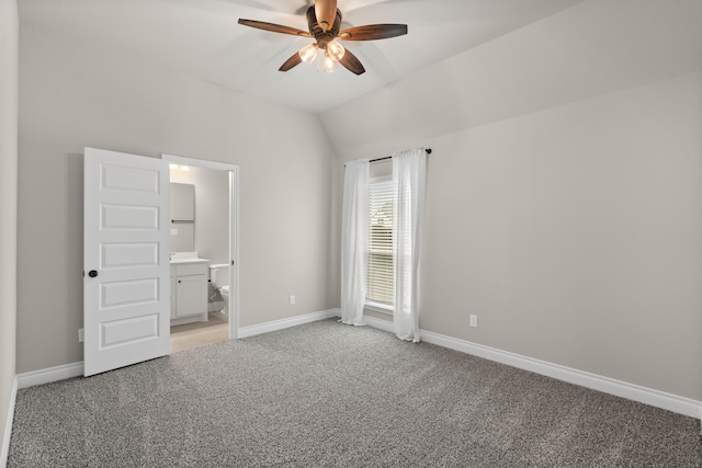 2915 Finch Ct, Katy, TX 77493 - unfurnished bedroom featuring light carpet, baseboards, vaulted ceiling, ensuite bath, and a ceiling fan