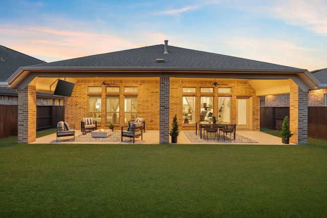 2915 Finch Ct, Katy, TX 77493 - back of property at dusk featuring outdoor lounge area, brick siding, a patio, and a shingled roof