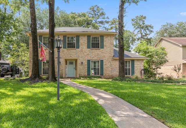5210 Nodaway Ln, Spring, TX 77379 - view of front of property with a front yard, brick siding, and a shingled roof