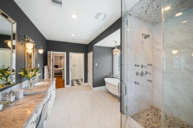2202 Sul Ross St, Houston, TX 77098 - full bathroom with a freestanding tub, a shower stall, vanity, marble look tile flooring, and baseboards