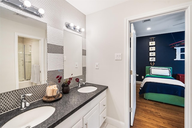 2202 Sul Ross St, Houston, TX 77098 - bathroom featuring double vanity, an enclosed shower, baseboards, decorative backsplash, and ensuite bath