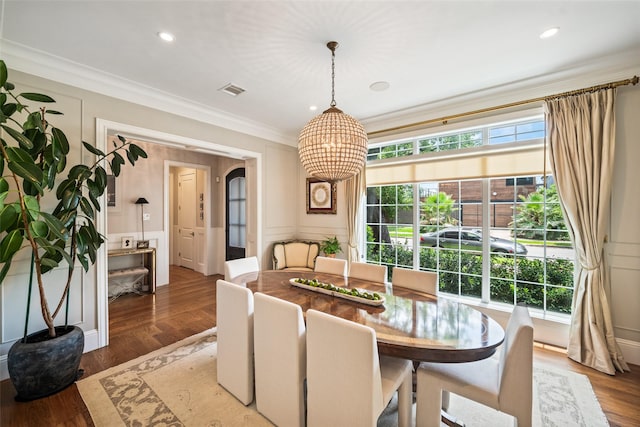 2202 Sul Ross St, Houston, TX 77098 - dining room featuring a chandelier, crown molding, a decorative wall, wood finished floors, and recessed lighting