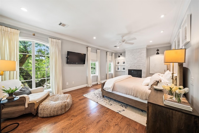 2202 Sul Ross St, Houston, TX 77098 - bedroom with baseboards, wood finished floors, a stone fireplace, crown molding, and recessed lighting