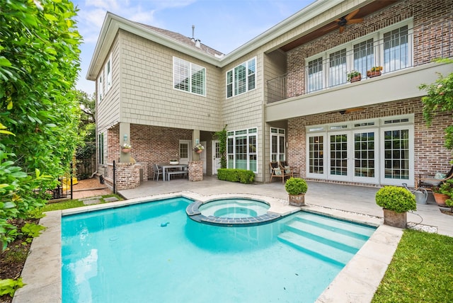 2202 Sul Ross St, Houston, TX 77098 - back of house featuring a patio area, a pool with connected hot tub, a balcony, and brick siding