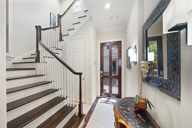 4305 Feagan St, Houston, TX 77007 - entryway featuring inlaid floor details, crown molding, tile patterned floors, stairs, and baseboards