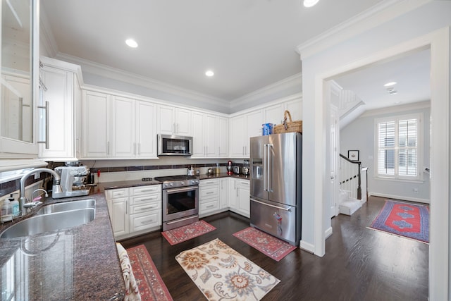 4305 Feagan St, Houston, TX 77007 - kitchen featuring stainless steel appliances, a sink, white cabinetry, dark wood-style floors, and ornamental molding