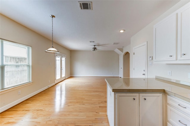 3721 Main Poplar Dr, Houston, TX 77025 - kitchen featuring ceiling fan, white cabinets, light wood-type flooring, hanging light fixtures, and recessed lighting