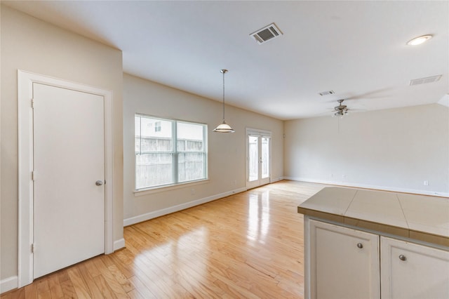 3721 Main Poplar Dr, Houston, TX 77025 - unfurnished dining area with ceiling fan, light wood-type flooring, and baseboards