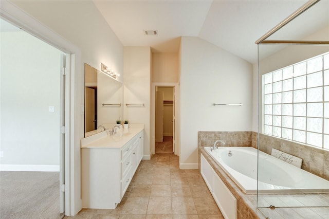 3721 Main Poplar Dr, Houston, TX 77025 - full bathroom featuring double vanity, a bath, lofted ceiling, a walk in closet, and baseboards