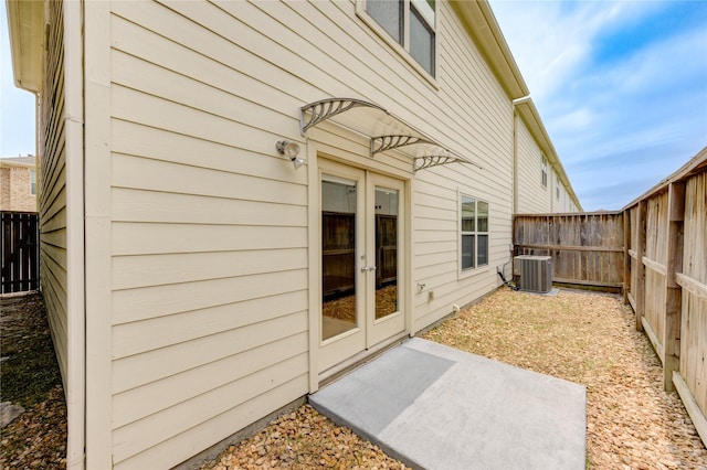3721 Main Poplar Dr, Houston, TX 77025 - view of exterior entry featuring french doors and central air condition unit