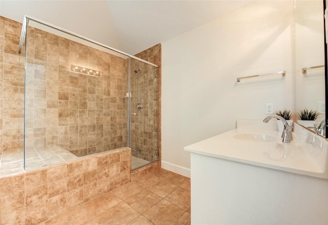 3721 Main Poplar Dr, Houston, TX 77025 - bathroom featuring tiled shower, vanity, baseboards, and tile patterned floors