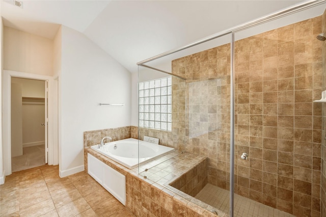 3721 Main Poplar Dr, Houston, TX 77025 - bathroom with lofted ceiling, a garden tub, a shower stall, a spacious closet, and tile patterned floors