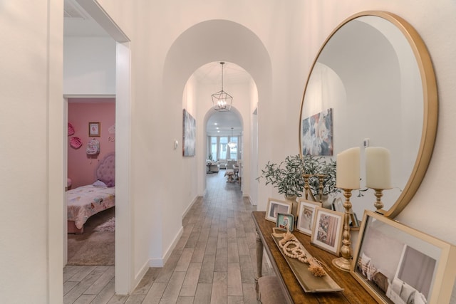 30707 Thicket Ct, Fulshear, TX 77441 - corridor with light wood-style flooring, arched walkways, and a high ceiling