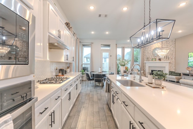 30707 Thicket Ct, Fulshear, TX 77441 - kitchen with appliances with stainless steel finishes, white cabinets, light countertops, decorative backsplash, and recessed lighting