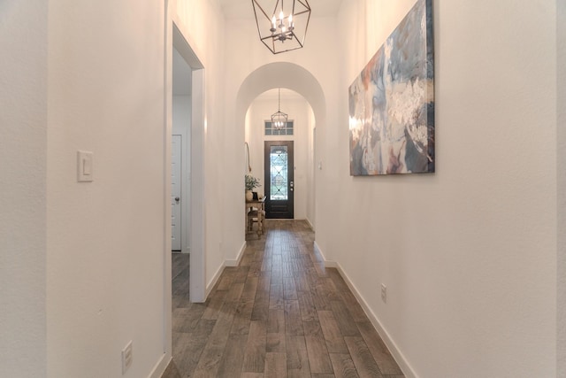 30707 Thicket Ct, Fulshear, TX 77441 - hall featuring arched walkways, dark wood finished floors, a chandelier, and a towering ceiling